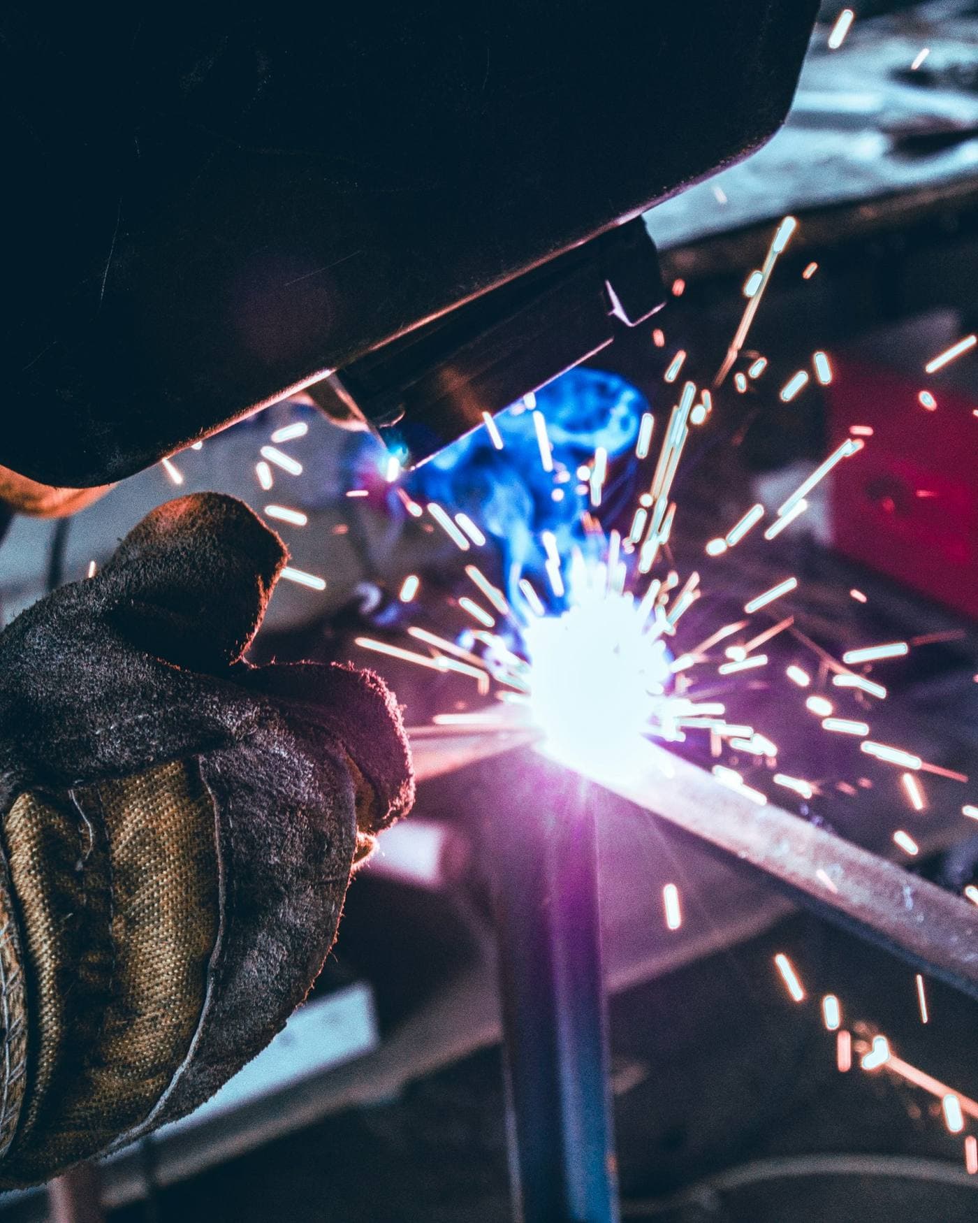 Welder working on metal in a workshop
